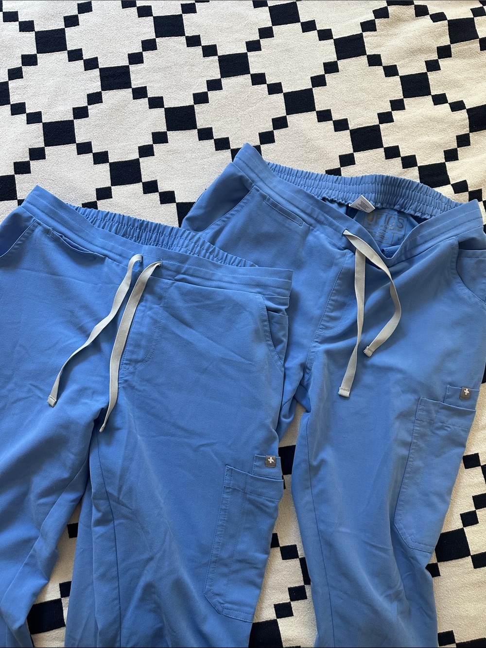 Two pairs of Yola skinny scrub pants
